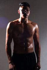 latin man posing on a dark background without a shirt. muscular man. fitness concept