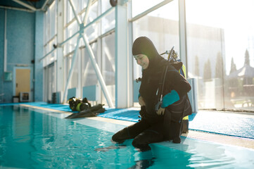 Male diver in scuba suit sitting at the poolside © Nomad_Soul