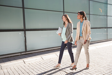 Businesswomen walking on city street