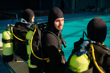 Divemaster and two divers preparing for the dive
