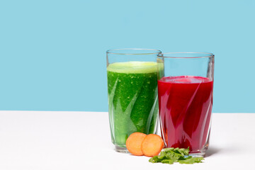 Beet and celery smoothie in glass cups with celery leaf, healthy eating environment
