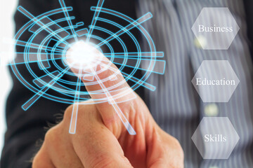 a businessmen is pressing a digital virtual button. Business, education and Skills are keyword for...