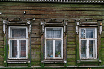 Fototapeta na wymiar A windows in the wall of an old wooden house