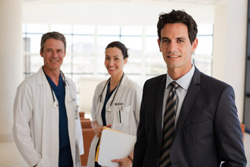 Doctor and businesswoman handshaking in meeting