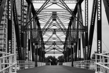 A black and white image of the view up the middle of the Detroit Swing Bridge in Salford Quays, Manchester.