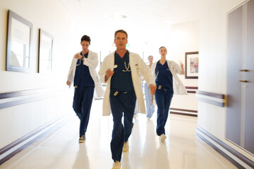 Doctors rushing down hospital corridor