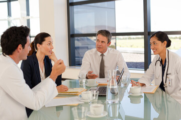 Portrait of smiling nurse in hospital corridor