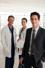 Portrait of serious doctor in hospital corridor