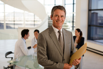 Doctor carrying folders in hospital