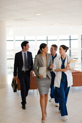Doctor carrying folders in hospital