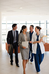 Doctor and senior patient talking in hospital room