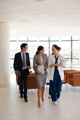 Doctor carrying folders in hospital