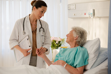 Doctor carrying folders in hospital