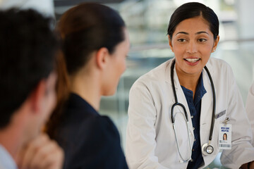 Doctors and businesswoman talking in meeting