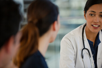 Doctors and businesswoman talking in meeting