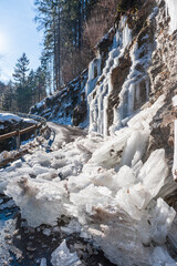 A lot of ice on a road, blocked due to an icefall