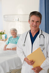 Portrait of smiling doctor with patient in background