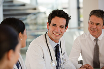 Doctors rushing down hospital corridor