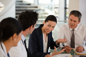 Doctors and businesswoman talking in meeting