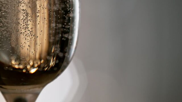 Super slow motion of champagne bubbles going up in flutes. Macro shot, filmed on high speed cinematic camera at 1000 frames per second.
