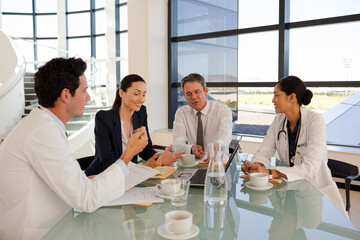 Portrait of smiling doctor in hospital corridor