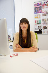 Portrait of businesswoman sitting at desk in office