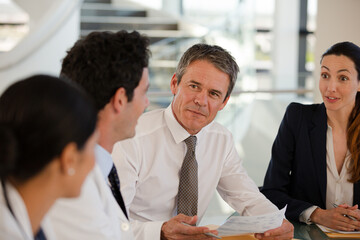 Doctors and businesswoman talking in meeting