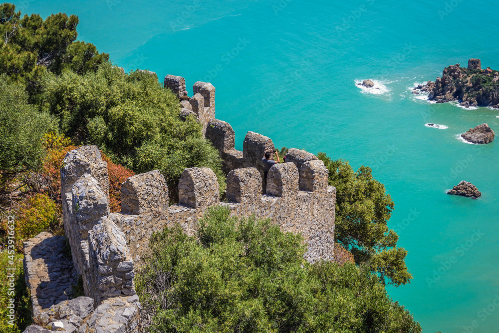 Wall mural Ruins of castle walls on La Rocca mountain in Cefalu on Sicily Island, Italy