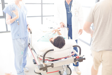Obraz premium Doctors rushing patient on gurney in hospital corridor