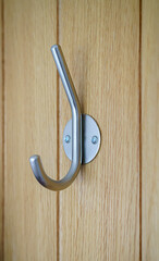 modern satin chrome door clothes hook fitted to a wooden beech doo