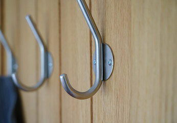 modern satin chrome door clothes hook fitted to a wooden beech doo