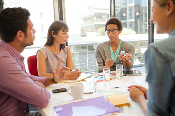 Business people examining model in meeting