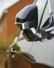 side profile with door mirror folded of a self charging hybrid SUV 