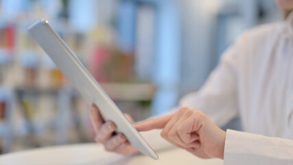Close Up of Woman Typing on Tablet kept on Table