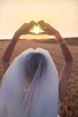 Fototapeta na wymiar Wedding woman holding hand on sunset background