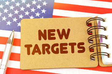 On the US flag lies a notebook with the inscription - New targets