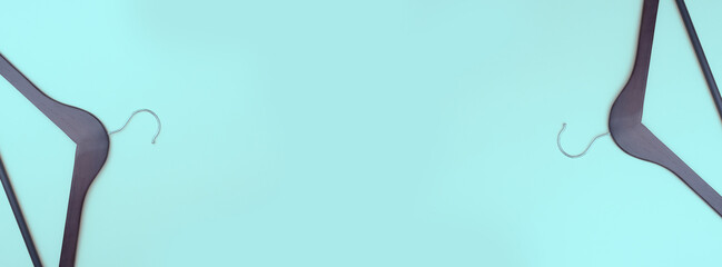 Banner. Wooden clothes hanger on a turquoise background. Copy space. Place for text. Shopping concept. Flat lay.