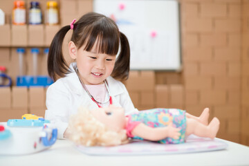 young girl pretend play doctor role  at home
