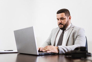 Businessman working in office with laptop and documents on his desk, consultant lawyer concept.