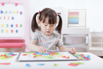 young girl playing creative toy blocks for homeschooling