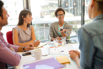 Business people examining model in meeting