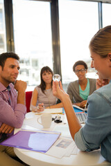 Business people examining model in meeting