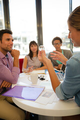 Business people examining model in meeting