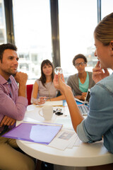 Business people examining model in meeting