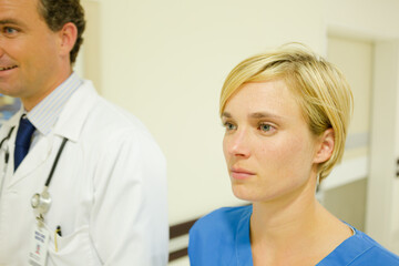 Fototapeta premium Nurse and doctor walking in hospital hallway