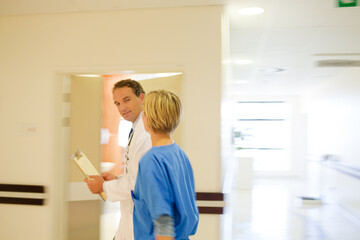 Nurse and doctor walking in hospital hallway