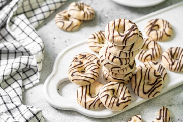 Cookies in white-black chocolate glaze on a light background