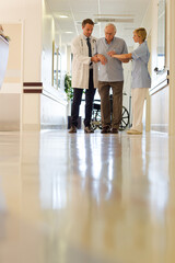 Fototapeta premium Doctor and nurse talking to patient in hospital room
