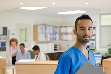 Doctor smiling in hospital hallway