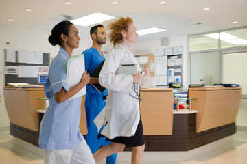 Fototapeta na wymiar Hospital staff rushing down hallway